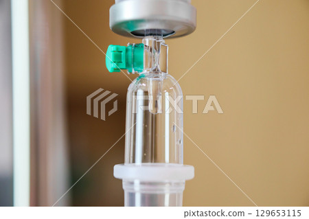 Close up medical intravenous IV drip in hospital background Close up medical intravenous IV drip in hospital background 129653115