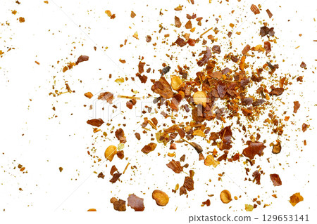 dried red chili pepper flakes and seeds isolated on white background dried red chili pepper flakes and seeds isolated on white background 129653141
