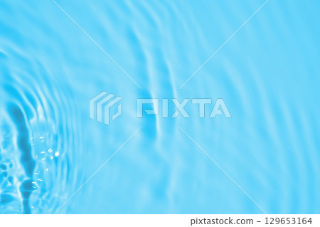Abstract transparent water shadow surface texture natural ripple on blue background Abstract transparent water shadow surface texture natural ripple on blue background 129653164