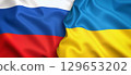 Russian and ukrainian flags waving together: international relations concept 129653202