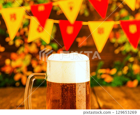 Oktoberfest bunting backdrop with close-up of a frothy, chilled beer stein 129653269