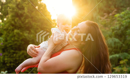Sunburst giggles and a baby's open mouthed wonder Sunburst giggles and a baby's open mouthed wonder 129653319