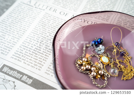 Bracelets and earrings on an accessory tray 129653580