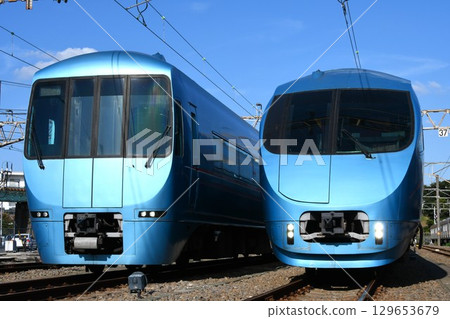 Odakyu Electric Railway 60000 series trains with through-cars (Fujisan markings) and non-through-cars (Bay Resort markings) lined up at the depot Odakyu Electric Railway 60000 series trains with through-cars (Fujisan markings) and non-through-cars (Bay Resort markings) lined up at the depot 129653679