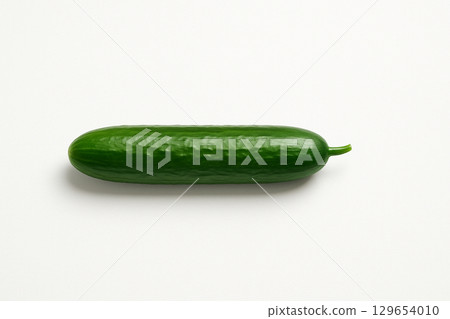 A simple green cucumber placed on a white background 129654010