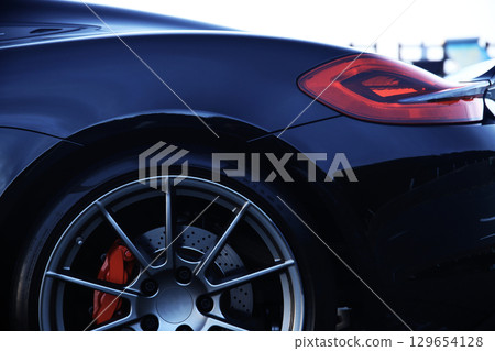 A shiny black sports car 129654128