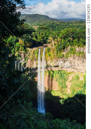 Highest Chamarel waterfall of Mauritius in the tropical jungle Highest Chamarel waterfall of Mauritius in the tropical jungle 129654283
