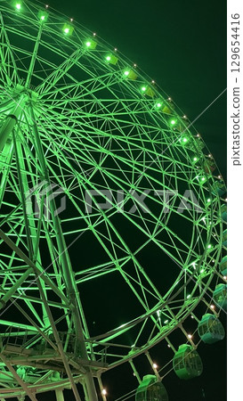 Lighted-up Ferris wheel 129654416