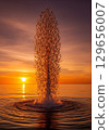 A stunning photograph of a 'solar flare' bursting from the ocean's surface at sunset, created by a massive school of fish moving in unison. 129656007