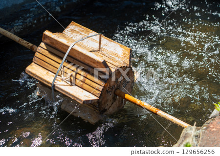 Waterwheel on a stream 129656256