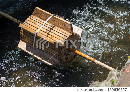 Waterwheel on a stream 129656257