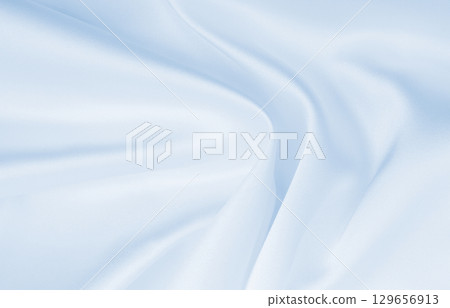 Smooth elegant blue silk or satin luxury cloth texture as abstract background. Luxurious background design Smooth elegant blue silk or satin luxury cloth texture as abstract background. Luxurious background design 129656913
