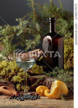 Gin in a small glass and an antique bottle of dark glass. 129657075