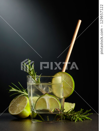 Cold refreshing drink with ice, lime, and rosemary. Cold refreshing drink with ice, lime, and rosemary. 129657122