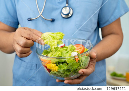 Asian Nutritionist holding healthy food for patient in hospital, nutrition and vitamin. 129657251