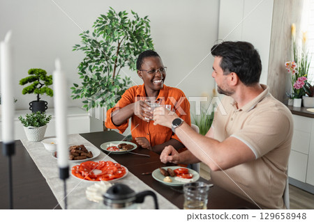 Happy Couple Toasting with Water During Lunch at Home Happy Couple Toasting with Water During Lunch at Home 129658948