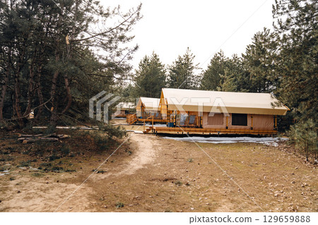 Glamping from tent houses in the forest.  129659888
