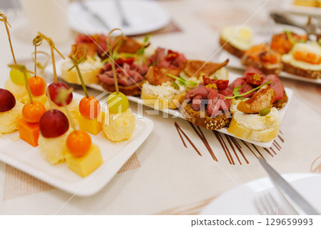 Assorted canapes for the festive table. Catering services for banquets.  129659993