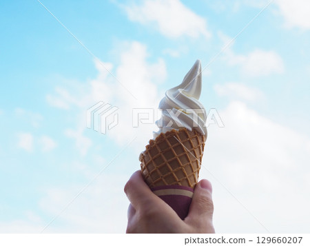 Soft serve ice cream with a blue sky in the background Soft serve ice cream with a blue sky in the background 129660207