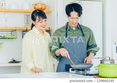 A couple cooking in the kitchen 129660295