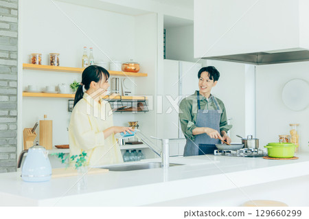 A couple cooking in the kitchen 129660299