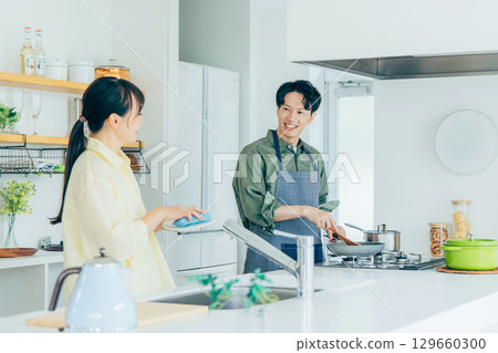 A couple cooking in the kitchen A couple cooking in the kitchen 129660300