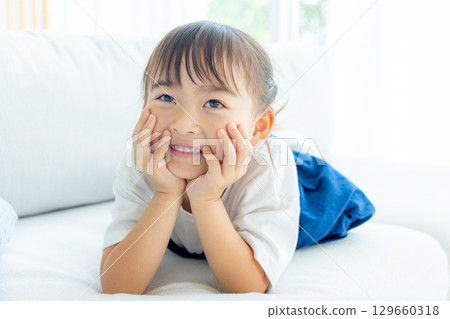 A girl with a smile on his cheeks 129660318
