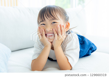 A girl with a smile on his cheeks 129660319