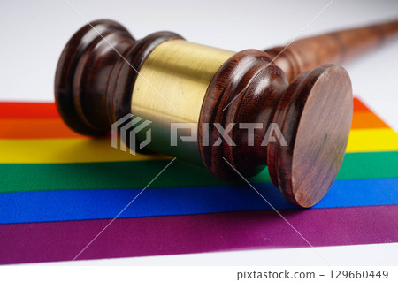 Gavel for judge lawyer on rainbow flag, symbol of LGBT pride month. 129660449