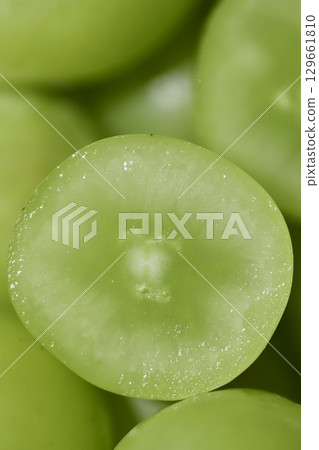Shine Muscat grapes removed from the bunch and cut in half 129661810