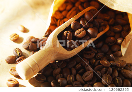 Coffee beans in a paper bag and a measuring scoop 129662265