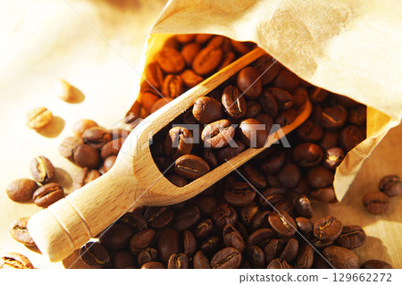 Coffee beans in a paper bag and a measuring scoop Coffee beans in a paper bag and a measuring scoop 129662272