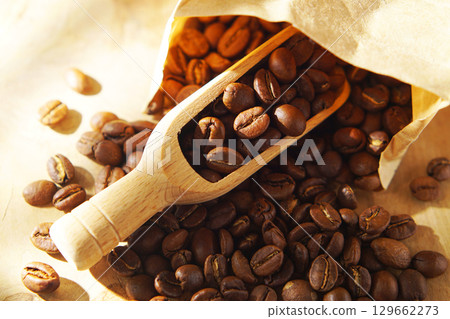 Coffee beans in a paper bag and a measuring scoop 129662273