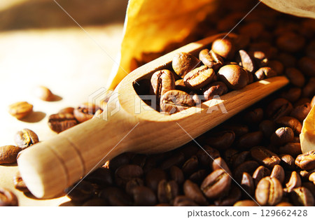 Coffee beans in a paper bag and a measuring scoop 129662428