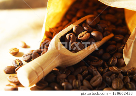 Coffee beans in a paper bag and a measuring scoop Coffee beans in a paper bag and a measuring scoop 129662433