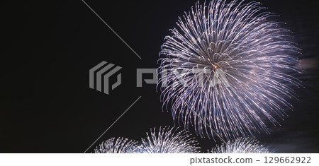 A spectacular fireworks display that lights up the night sky with multiple fireworks 129662922
