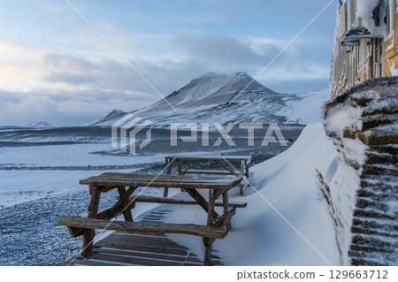 Snow-covered mountain hut and outdoor table in the Icelandic highlands Snow-covered mountain hut and outdoor table in the Icelandic highlands 129663712