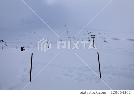 Snowy mountain ski-lift no people, blue sky, azure, air, freshness, ecology. High quality photo 129664362