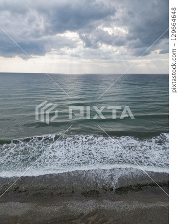 Sunset ocean waves. Sunset ocean horizon. High quality 4k footage 129664648