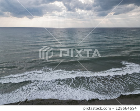 Sunset ocean waves. Sunset ocean horizon. High quality 4k footage 129664654