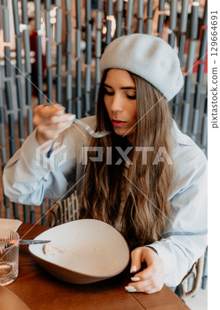 Woman Eating Restaurant Dessert Meal 129664691