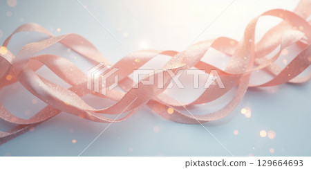 Interwoven ribbons in pastel hues twist elegantly into infinity loops, set against a clean white canvas; overhead camera angle captures 129664693