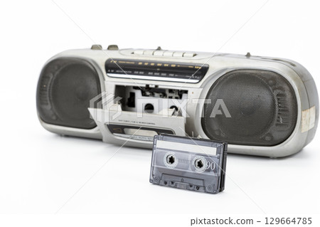 Vintage cassette player with open tape deck, retro audio system, nostalgic old technology on white. Vintage cassette player with open tape deck, retro audio system, nostalgic old technology on white. 129664785
