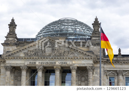 Berlin, Germany - July 01, 2018: Flags on the background of the Reichstag building Berlin, Germany - July 01, 2018: Flags on the background of the Reichstag building 129665123
