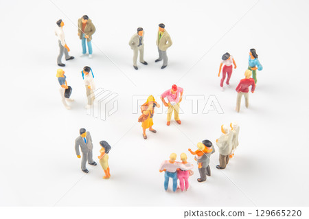 Miniature figures circle up, chatting and interacting in a playful scene Miniature figures circle up, chatting and interacting in a playful scene 129665220