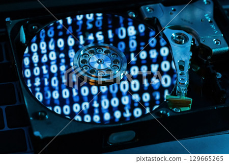 A hard disk with an abstract reflection of the binary code A hard disk with an abstract reflection of the binary code 129665265