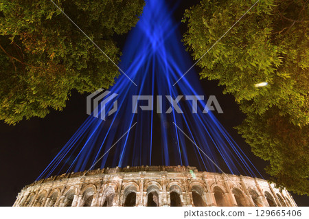 Nîmes, France. The Roman Amphitheater at night, illuminated by lights from an event, on August 12, 2025. 129665406