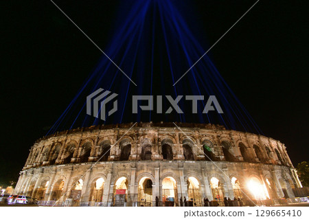 Nîmes, France. The Roman Amphitheater at night, illuminated by lights from an event, on August 12, 2025. 129665410