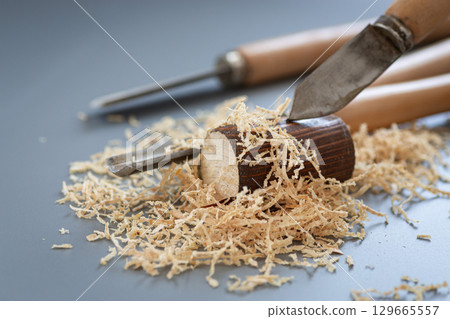 Chisels and wood dust in craftsman's workshop Chisels and wood dust in craftsman's workshop 129665557