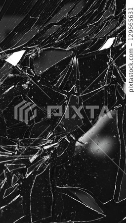 Dirty Glass Broken into a Large Number of Pieces and Parts, a Piece of Glass with a lot of Cracks and Broken Parts. Isolated on Black Background. 129665631